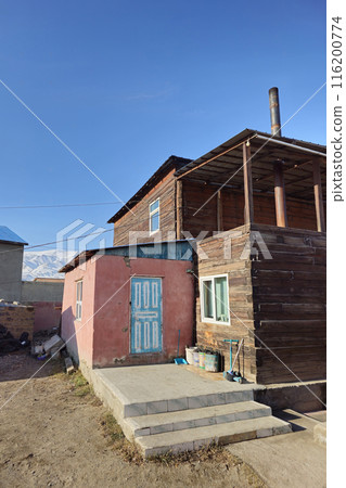 Old wooden private house with a porch. Old wooden private house with a porch. 116200774