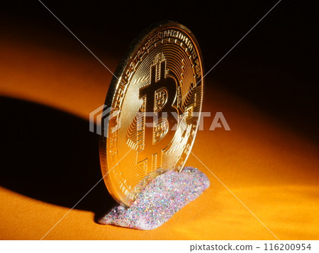 A gold coin with the letter B on it is sitting on a table 116200954