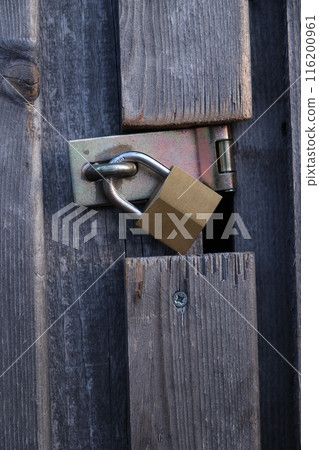 A wooden door with a lock on it A wooden door with a lock on it 116200961