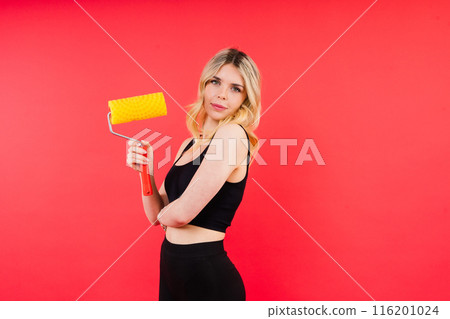 Young minded employee laborer handyman woman choosing roller brush paint 116201024
