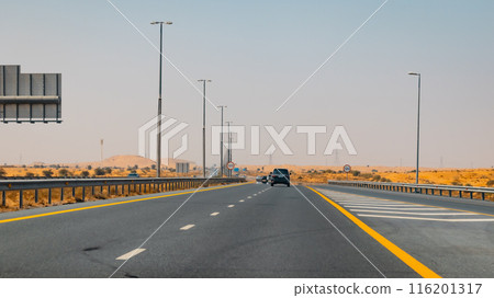 Fujairah mountains, extension of Omani Al Hajar mountain range. Cloudy winter day on empty street. High quality photo 116201317
