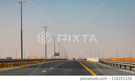 Fujairah mountains, extension of Omani Al Hajar mountain range. Cloudy winter day on empty street. High quality photo 116201320
