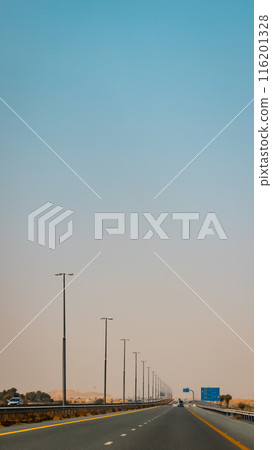 Fujairah mountains, extension of Omani Al Hajar mountain range. Cloudy winter day on empty street. High quality photo 116201328