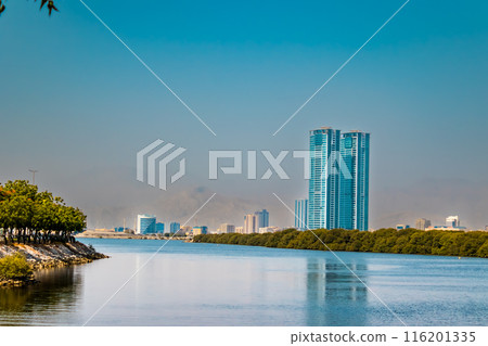 embankment of the city of Donetsk along the Kalmius river. Multi-storey buildings rise. A bridge crosses the river connecting part of the city. High quality photo 116201335