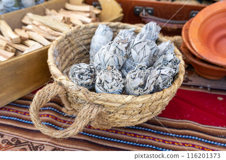 White sage also known as Salvia apiana, smudge sticks, herbal bundles in wicker basket, ceremonial use 116201373