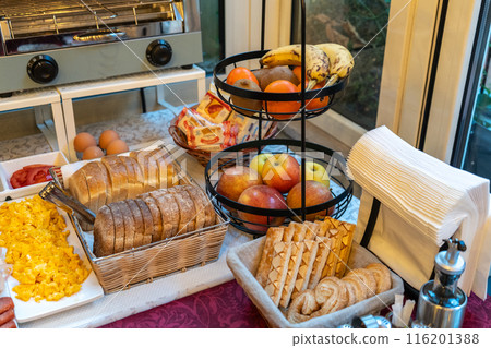 Italian hotel breakfast buffet, pastries, croissants, cookies, cereal dispensers, cold cuts, cheese slices Italian hotel breakfast buffet, pastries, croissants, cookies, cereal dispensers, cold cuts, cheese slices 116201388