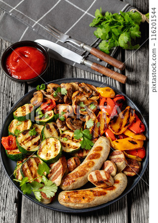 grilled white sausages with veggies and mushrooms 116201544