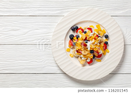 fresh berries, banana with corn flakes and yogurt 116201545