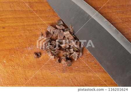 Finely chopped anchovy fillet, marinated fish, traditional salted anchovy in oil on wood 116201624