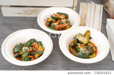 Cucumber kimchi, oi sobagi, or Korean cucumber pickle in bowls. Oi kimchi, with sesame seeds, spicy cucumbers Cucumber kimchi, oi sobagi, or Korean cucumber pickle in bowls. Oi kimchi, with sesame seeds, spicy cucumbers 116201625