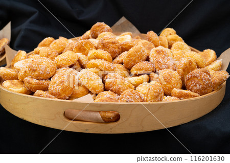 Puff pastries, round sugar-coated sugar puffs, golden crispy baked sweets, traditional French patisserie Puff pastries, round sugar-coated sugar puffs, golden crispy baked sweets, traditional French patisserie 116201630