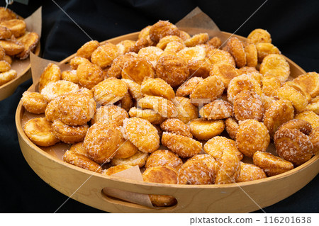 Puff pastries, round sugar-coated sugar puffs, golden crispy baked sweets, traditional French patisserie 116201638