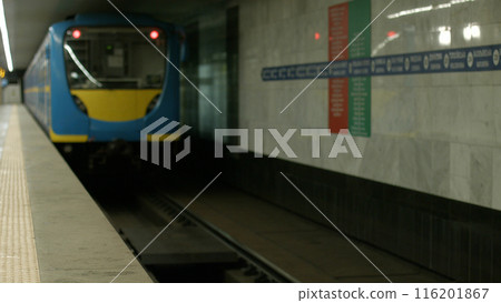 The subway train pulls away from the platform. The new metro station is beautiful and clean. 116201867