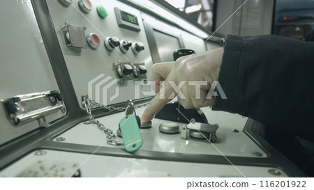 The train driver presses the button. Metro train control panel. The train driver presses the button. Metro train control panel. 116201922