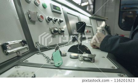 Train driver controls the subway. Checking the instrument panel. Train driver controls the subway. Checking the instrument panel. 116201923