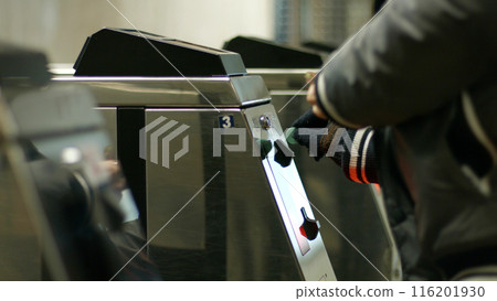 Turnstile to the metro station. People use the token to pay for their fare. 116201930