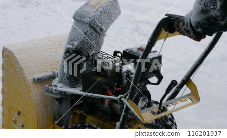 Snow removal machine winter season. The janitor removes the snow. 116201937
