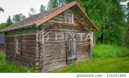 Ancient wooden hut surrounded by greenery in Finland Ancient wooden hut surrounded by greenery in Finland 116201969