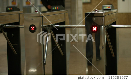 Turnstiles in the subway. People pass through the turnstiles. Check point. 116201977