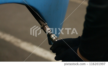 Locomotive repair. The craftsman repairs the hydraulic system. 116201997