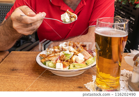 Polish Caesar salad with chicken, bacon and vegetables, high-calorie meat salad with fresh vegetables 116202490