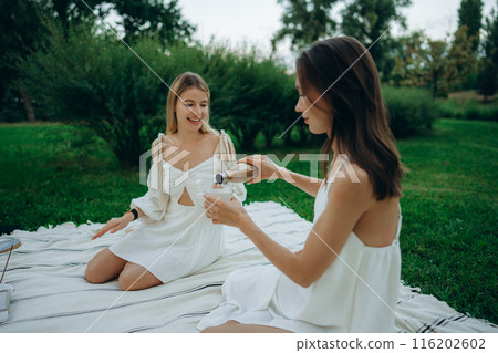 Two young women meditate and do yoga in nature. Two young women meditate and do yoga in nature. 116202602
