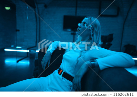 Portrait of a blonde in neon glasses. 116202611