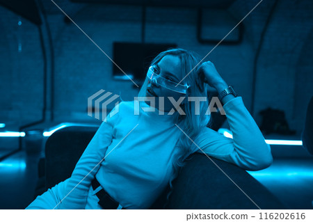 Portrait of a blonde in neon glasses. 116202616