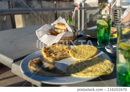 Moroccan hotel breakfast also known as ftour, msemen, baghrir, harcha, mint tea, bread basket 116202670