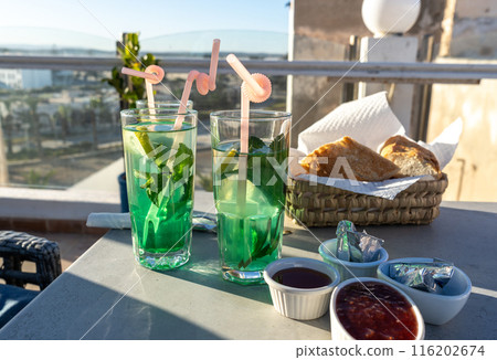 Moroccan hotel breakfast, also known as ftour, mint tea, bread basket, outdoor dining, morning meal 116202674