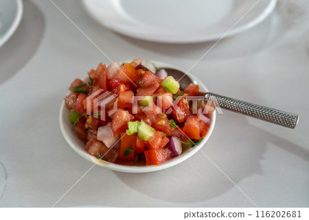 Popular Moroccan salad for tourists, diced tomatoes, cucumbers, onions, and fresh herbs 116202681