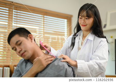 Physiotherapy specialist applying kinesio tape on the shoulders and neck of athlete patient. Sport physical therapy concept Physiotherapy specialist applying kinesio tape on the shoulders and neck of athlete patient. Sport physical therapy concept 116202936