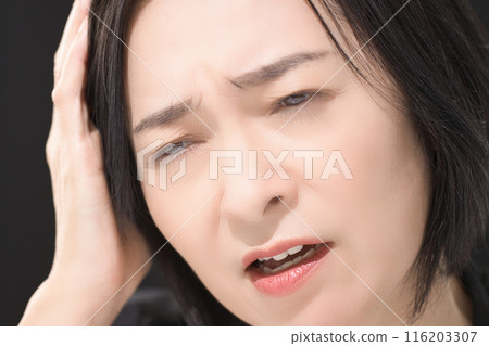 Middle-aged woman with a tired expression Middle-aged woman with a tired expression 116203307