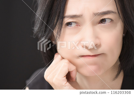 Middle-aged woman with an angry expression Middle-aged woman with an angry expression 116203308