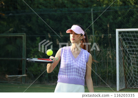 Woman Keeping The Ball In The Air With The Racket  116203335