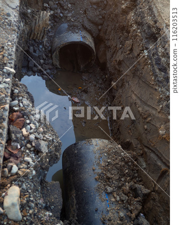 Works on the replacement of sewer pipes. Thick pipes underground. Earthworks with communications. Utility services. Sawn pipe. 116203513