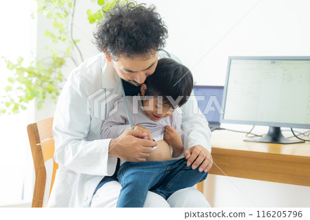 Male doctor examining a boy 116205796