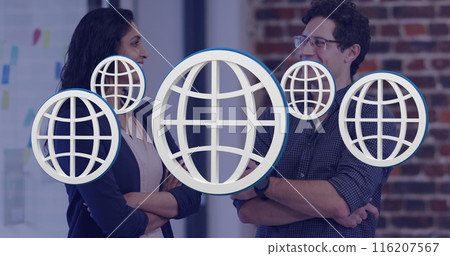 Image of multiple web globe icons floating against diverse man and woman smiling at office 116207567