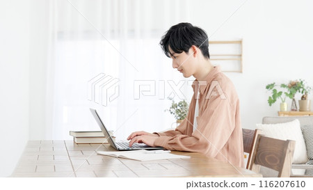 Man using laptop at home Man using laptop at home 116207610