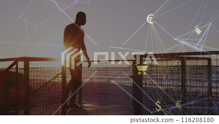 Image of connected icons globe over silhouette on man running up stairs at beach after jogging 116208180