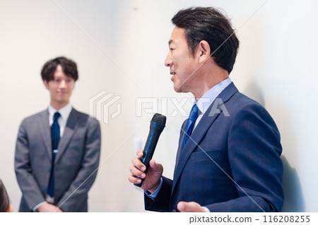 Middle-aged man giving a speech using a microphone Middle-aged man giving a speech using a microphone 116208255