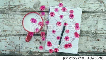 A close-up of a coffee cup, notepad, and pen on a wooden plank, with an image of a network of connec 116208286