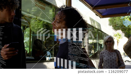 Image of graphs, globes and computer language, diverse friends talking at bus stop Image of graphs, globes and computer language, diverse friends talking at bus stop 116209077