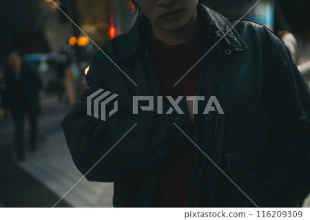 Man putting his hands in his inner pocket 116209309