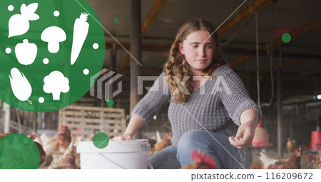 Image of vegetable icons and spots over caucasian woman feeding the chickens in poultry farm 116209672