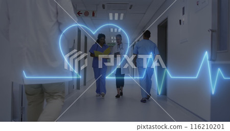 Image of heart rate monitor over diverse female doctor and healthworker discussing at hospital 116210201