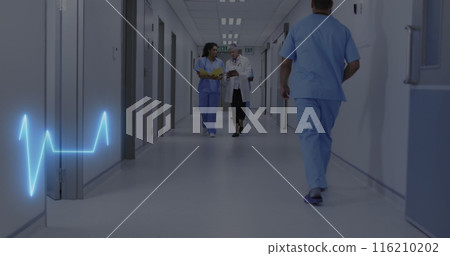 Image of heart rate monitor over diverse female doctor and healthworker discussing at hospital 116210202
