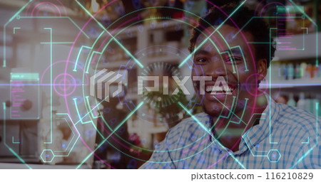 Image of data processing over smiling african american man in cafe 116210829