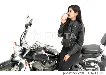 Biker girl drinking coffee on the bike 116211178