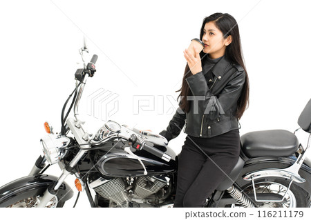 Biker girl drinking coffee on the bike 116211179